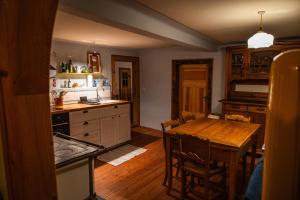 a kitchen with a wooden table and a dining room at Landhausromantik pur in Kirchheim +13 photos