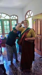 a woman standing next to a man cutting her hair at Kuma Beach side Villa in Wadduwa