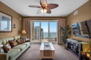 a living room with a couch and a large window at Ariel Dunes I 1404 in Destin