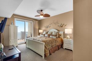 a bedroom with a bed and a balcony at Ariel Dunes I 1404 in Destin