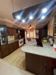 a kitchen with a counter top and a kitchen island at Nerman home in ‘Awjān ash Shamālī +4 photos