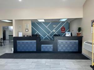 a lobby with a reception desk in a building at Super 8 by Wyndham Grand Island in Grand Island