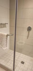 a shower with a glass door in a bathroom at Zimbali Suite 207 in Ballito