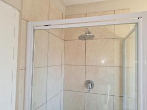 a shower in a bathroom with a glass door at Rue's place in East London +20 photos