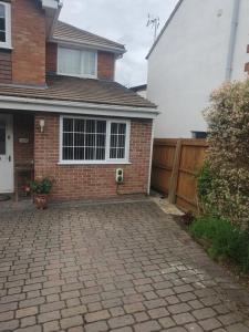 a brick driveway in front of a house at The Annex @ 136 in Gloucestershire