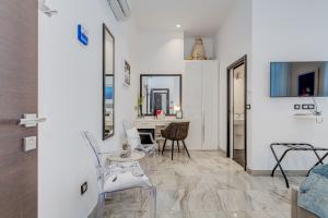 een woonkamer met witte muren en een tafel en stoelen bij Tango Rooms in Split