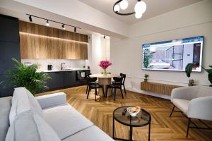 a living room with a couch and a table at Apartament Indigo 11 by Housine in Zator