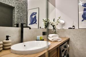 a bathroom with a white sink and a mirror at Apartament Indigo 11 by Housine in Zator +29 photos