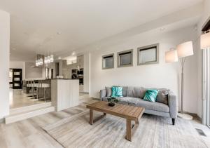 a living room with a couch and a table at Newly Renovated Vacation Home w/ Hot Tub & Garage in Calgary