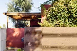 a wooden fence with a wooden roof on top of it at Silver Lake Mid-century Nestled In The Treetops in Los Angeles