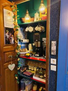 a kitchen with a pantry filled with lots of food at La Babayaga in Capestang +43 photos