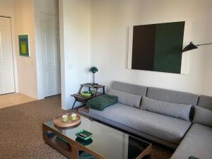 a living room with a couch and a table at Dog friendly Mid-Century style condo with poolspa in La Quinta