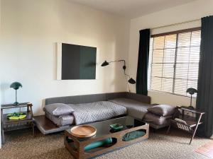 a living room with a couch and a table at Dog friendly Mid-Century style condo with poolspa in La Quinta +23 photos