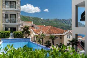 a view from the balcony of a building with a swimming pool at The Dream Getaway & Spa by DeVasco in Bečići