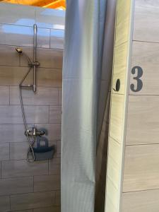 a shower in a bathroom with a shower curtain at Kuća za odmor KRNJAIĆ,porodični KAMP in Bosanski Novi