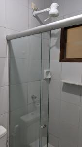 y baño con ducha y puerta de cristal. en Pousada Solar da Praia, en Tamandaré