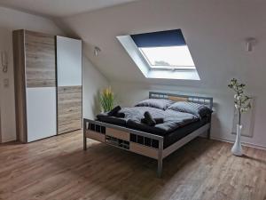 a bedroom with a bed and a skylight at Pension Asche in Leese