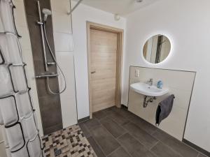 a bathroom with a sink and a shower at Pension Asche in Leese