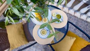 a glass table with two hats and cups on it at Apartments Arina in Krašići