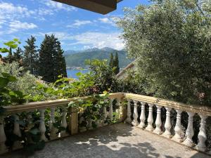 a balcony with a fence with a view of the water at Apartments Arina in Krašići