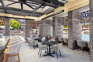 a restaurant with tables and chairs and windows at Hyatt Regency Scottsdale Resort and Spa in Scottsdale