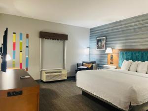 a hotel room with a bed and a desk at Hampton Inn Atlanta-Canton in Canton +21 photos