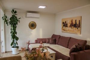a living room with a couch and a table at Villa Bali - Aladinici in Stolac