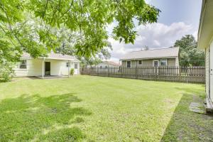 a yard with two houses and a fence at Centrally Located Gonzales Home with Yard! in Gonzales