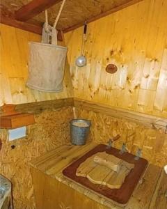 a bathroom with a sink in a wooden cabin at La cabane perchée du trappeur in Écrainville