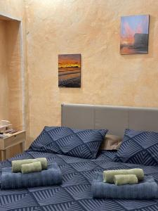 a bed with two pillows on top of it at La Grotta dell'Orso in Aosta +19 photos