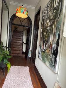 a hallway of a house with a painting on the wall at Dans L'Atelier Hostel Unidade Porta Nova in Braga