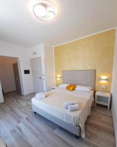 a bedroom with a large bed with two towels on it at B&B Selene in San Vito lo Capo