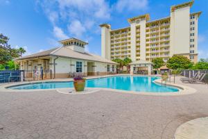 a swimming pool in front of a hotel at Perdido Key Condo with Views and Golf Club Access! in Pensacola