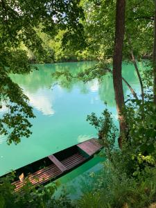 a bridge in the middle of a body of water at Kuća za odmor KRNJAIĆ,porodični KAMP in Bosanski Novi +5 photos