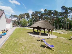 a gazebo with two chairs and a table at Stania Scandinavian CENTRUM in Boszkowo-Letnisko