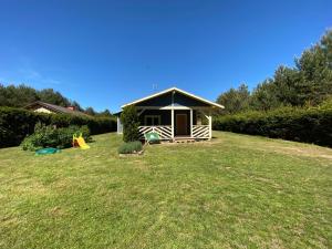 a small house in a yard with a playground at Sosenkowe Zacisze in Ciche +18 photos
