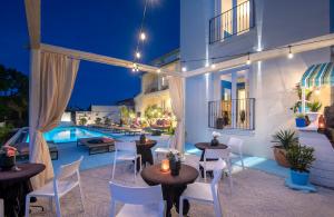 a patio with tables and chairs and a pool at Vinkuran Residence - Adults Only in Pula