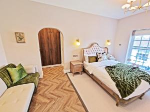 a bedroom with a large bed and a couch at Elevated Space Apartments, Shipston on Stour in Shipston on Stour