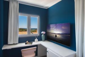 a blue room with a desk and two windows at Vinkuran Residence - Adults Only in Pula