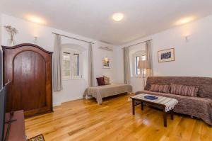 a living room with a couch and a table at Apartment City Center in Jelsa