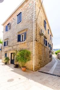 a large brick building with windows on a street at Apartment City Center in Jelsa