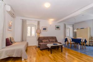 a living room with a couch and a table at Apartment City Center in Jelsa