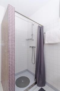 a shower with a shower curtain in a bathroom at Apartment City Center in Jelsa +12 photos