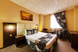 a hotel room with a bed and a table at Marton Severnaya Krasnodar in Krasnodar