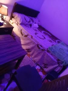 a bed in a room with a purple room at Khalidiya in Abu Dhabi