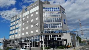 a large office building with a lot of windows at Hotel San Marinho in União da Vitória