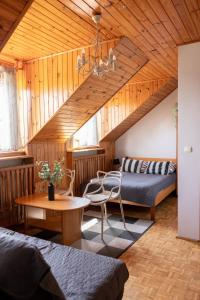 a bedroom with two beds and a table in a room at SunRise Mielno in Mielno