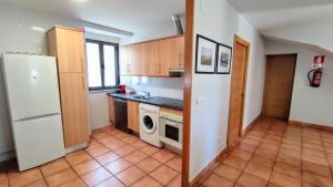 a kitchen with a white refrigerator and a dishwasher at CASA LA VILLA in Villamartín de Don Sancho +62 photos