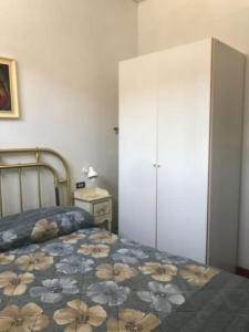 a bedroom with a bed and a white cabinet at La casetta di Angelo! in San Giovanni in Marignano