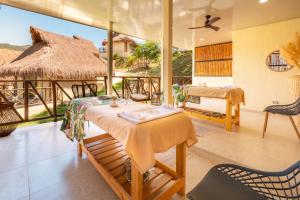 a dining room with a table and a thatch roof at Hotel Alto de Pajas Boutique by H&R in Villeta